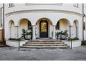 Inviting front entrance with a series of archways, pillars and stone steps at 3280 Cherryridge Rd, Cherry Hills Village, CO 80113