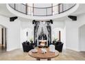 Magnificent foyer with a marble fireplace, open balcony, and curved architecture at 3280 Cherryridge Rd, Cherry Hills Village, CO 80113