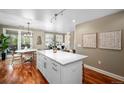 Open kitchen layout with white cabinetry, stainless steel appliances and view to the patio at 1631 N Emerson St # 117, Denver, CO 80218