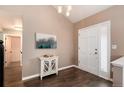 Welcoming entryway featuring a white console table, decorative art, and stylish lighting at 9866 Spring Hill Ln, Highlands Ranch, CO 80129