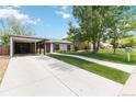 Charming home with modern siding, covered parking, and a long, decorative driveway at 3040 S Dexter Way, Denver, CO 80222
