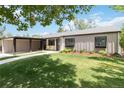 Charming home featuring a well-manicured lawn, modern siding, and covered parking at 3040 S Dexter Way, Denver, CO 80222