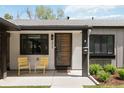 Inviting front porch featuring a modern door, stylish seating, and well-maintained landscaping at 3040 S Dexter Way, Denver, CO 80222
