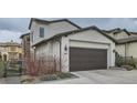 Spacious two-car garage with dark brown door offering ample parking and storage space at 2640 S Orchard St, Lakewood, CO 80228