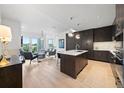 Open concept living space features modern kitchen with sleek cabinetry and an island at 155 Steele St # 414, Denver, CO 80206