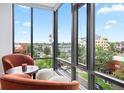 Relaxing nook with cityscape view from expansive windows and cozy decor at 155 Steele St # 414, Denver, CO 80206