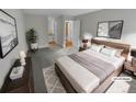 Virtually staged main bedroom with a plush bed and en-suite bathroom access at 2685 S Dayton Way # 74, Denver, CO 80231