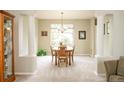Neutral dining room with a chandelier, decorative columns and picture window at 1210 Snowberry Ln, Broomfield, CO 80020