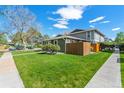 Exterior view of a single-story home featuring a well-maintained lawn with sidewalk at 9901 E Evans Ave # 9A, Aurora, CO 80247