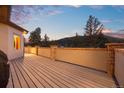 Spacious back deck with mountain views and wood flooring, ideal for outdoor entertaining at 21016 Horse Bit Way, Morrison, CO 80465