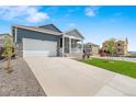 Beautiful home with a wide driveway, manicured lawn, and inviting front porch at 4530 Cattle Cross Trl, Castle Rock, CO 80104