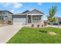 Inviting home with a landscaped front yard, a two-car garage, and an attractive stone and siding facade at 4530 Cattle Cross Trl, Castle Rock, CO 80104