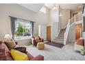 Bright living room boasts vaulted ceilings, a large window, and neutral decor at 13439 Antlers St, Broomfield, CO 80020
