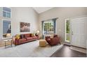 Inviting living room bathed in natural light with high ceilings and cozy decor at 13439 Antlers St, Broomfield, CO 80020