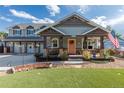 Inviting front porch with rocking chairs, manicured landscaping, and a cheerful front door at 10640 W 46Th Ave, Wheat Ridge, CO 80033