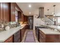 Gourmet kitchen with custom cabinets, sleek countertops, stainless steel appliances, and stylish backsplash at 10640 W 46Th Ave, Wheat Ridge, CO 80033