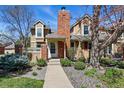 Charming exterior of a two-story home featuring a brick chimney, manicured landscaping, and a welcoming front entrance at 9917 Grove Way # A, Westminster, CO 80031