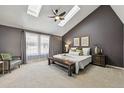 Comfortable main bedroom with vaulted ceilings, skylights, neutral carpet, and great natural light at 9917 Grove Way # A, Westminster, CO 80031