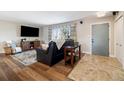 Living area with hardwood floors, a fireplace, and a view of the entry way at 5510 W 103Rd Ave, Westminster, CO 80020