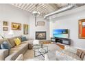 Spacious living room boasts a fireplace, large TV, and comfortable seating at 1435 Wazee St # 504, Denver, CO 80202