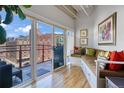 Bright sunroom with built-in seating and access to a balcony at 1435 Wazee St # 504, Denver, CO 80202