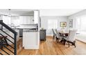 Open kitchen and dining area with stainless steel appliances, granite countertops, and seating for six at 2048 Meade St, Denver, CO 80211