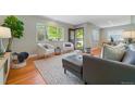 Inviting living room boasts hardwood floors, contemporary decor, and natural light at 3245 S High St, Englewood, CO 80113