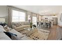 Spacious living room featuring an open floor plan and kitchen views at 824 Ledge St, Lochbuie, CO 80603