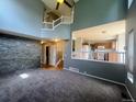 Open concept living space, with a view of the kitchen and staircase, perfect for modern living at 12742 Clermont St, Thornton, CO 80241