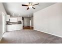 Bright living room showcases neutral carpet, recessed lighting, and open floor plan at 7326 Green River Ave, Frederick, CO 80530