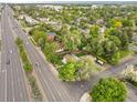 An aerial shot showing the property, mature trees, landscaping, and road in a residential area at 5 S Wadsworth Blvd, Lakewood, CO 80226