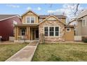Charming two-story home with stone accents, a welcoming front porch, and a well-manicured lawn at 14214 Waterside Ln, Broomfield, CO 80023