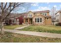 Attractive two-story home with stone facade, porch, and a neatly kept lawn, exuding curb appeal at 14214 Waterside Ln, Broomfield, CO 80023