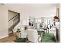 Open concept living area features hardwood floors, a cozy sofa, and plenty of natural light at 2134 S Galapago, Denver, CO 80223