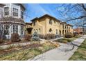 Beautiful exterior view of a multi-Gathering stucco home with a private front yard and sidewalks at 7651 E 26Th Ave, Denver, CO 80238