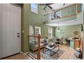 Inviting living room with high ceilings, a cozy seating area, and natural light at 7651 E 26Th Ave, Denver, CO 80238