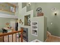 Inviting living room showcases a fireplace, wall decor, open staircase, and an abundance of natural light at 7651 E 26Th Ave, Denver, CO 80238