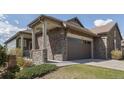 Charming home with a stone and siding exterior and a two-car garage at 16406 W 85Th Ln # A, Arvada, CO 80007