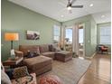 Bright and airy living room with hardwood floors, comfortable seating, and access to a balcony at 16406 W 85Th Ln # A, Arvada, CO 80007