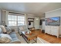 Comfortable living room with hardwood floors, large window, and stylish furnishings at 2870 Jasmine St, Denver, CO 80207