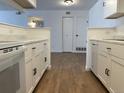 Well-designed kitchen featuring white cabinets, marble countertops, and modern appliances at 943 S Zeno Way # 205, Aurora, CO 80017