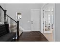 Welcoming foyer with hardwood floors, staircase, and adjacent office space at 3234 Picketwire Way, Castle Rock, CO 80108