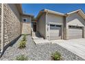 Eye-level front exterior view of a home with stone accents and low-maintenance landscaping at 366 Agoseris Way, Castle Rock, CO 80104