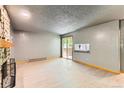 The living room features neutral flooring, an accent bar, and a glass sliding door at 4070 S Atchison Way # 101, Aurora, CO 80014