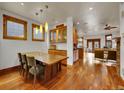 Spacious dining room with hardwood floors, wood trim, large windows and decorative lighting at 383 S Franklin St, Denver, CO 80209