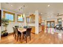 Bright dining room featuring hardwood floors, a modern light fixture, and built-in cabinetry for elegant dining at 383 S Franklin St, Denver, CO 80209