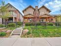 Charming home featuring a well-kept lawn, decorative fence, and covered front porch at 383 S Franklin St, Denver, CO 80209