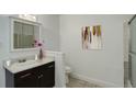 Well-lit bathroom with vanity, decorative mirror, and shower-tub combination at 2565 S Sheridan Blvd # 14, Lakewood, CO 80227
