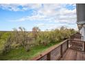 Enjoy this balcony view overlooking lush green trees and blue skies at 6240 Everett Ct # D, Arvada, CO 80004