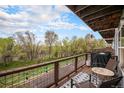 Relax on the balcony with grill, furniture, and views of the lush trees at 6240 Everett Ct # D, Arvada, CO 80004
